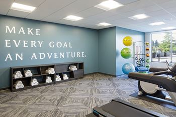 Fitness room with cardio and weight equipment at Harbor Heights 55+ Community, Olympia, Washington